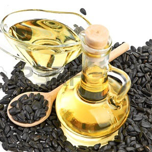 21815867-sunflower-seeds-and-oil-in-bottle-on-a-white-background